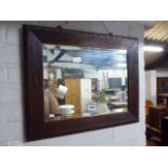 Dark oak framed and bevelled rectangular wall mirror