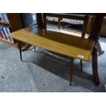 Mid century coffee table with brass magazine shelf below on tapered black supports