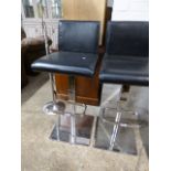 Black leatherette upholstered bar stool on chrome support