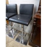 Black leatherette upholstered bar stool on chrome support