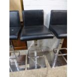 Black leatherette upholstered bar stool on chrome support