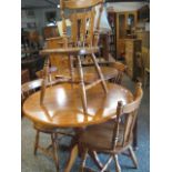 Circular oak pedestal table with 3 slat back chairs