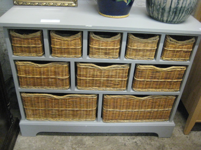 Grey multi compartment cabinet with wicker basket drawers