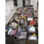 Table top containing 20 boxes of CDs incl. New Order, Iggy Pop, The Wombats, Kaiser Chiefs, etc.