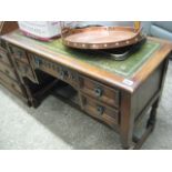 Leather inlaid oak writing desk with 5 drawers