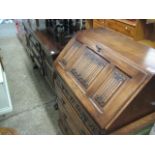 Oak sideboard with central drawers flanked by cupboards and matching fall front bureau with 4