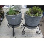 2 concrete effect planters on metal stands