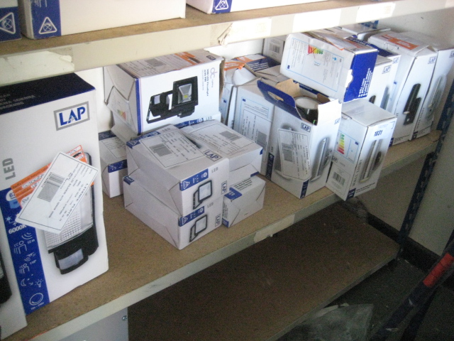 Shelf containing large quantity of various LAP security wall lights