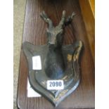 Cast metal stag's head on wooden plaque