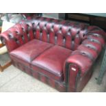 Red Chesterfield style button back leather upholstered 2 seater sofa