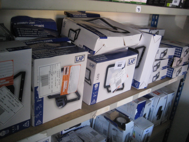 Shelf containing a large quantity of various LAP security lights