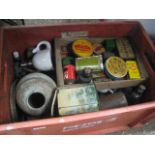 Red crate of various tins and homewares