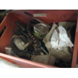 Red crate of various tins and homewares