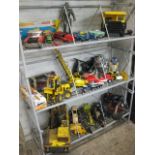 3 shelves of mixed children's toys incl. Commodore clockwork cruiser, Matchbox tipper truck, Tonka