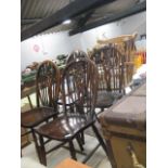 Set of 4 matching wheel back dining chairs, 1 other wheel back chair and lighter coloured armchair