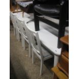 Large modern white extending dining table with 8 matching upholstered dining chairs