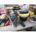 Table top containing a large quantity of various tools, acro props, tyre inflator, foot pump, etc