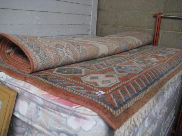 Large orange and blue figured and bordered rug