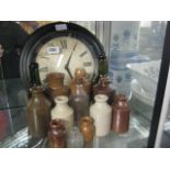 Wall clock and quantity of earthenware bottles