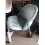Green tub style chair on tubular metal base with spare base