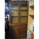 Yew glazed display bookcase with cupboard storage below
