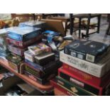 1.5 table tops of puzzles (many still wrapped) and games