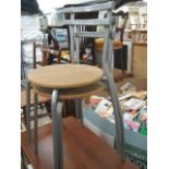 Pair of stackable metal framed chairs with wood effect seats