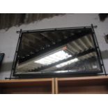 Large black framed and bevelled wall mirror