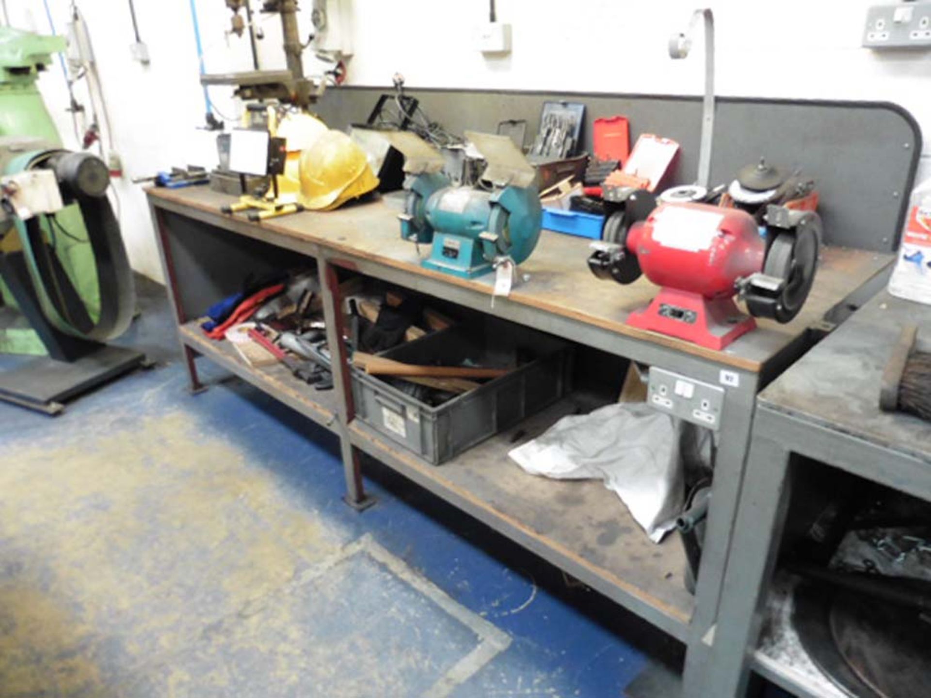 8' wide metal and wood work bench with 2 single phase double ended bench grinders and electrical