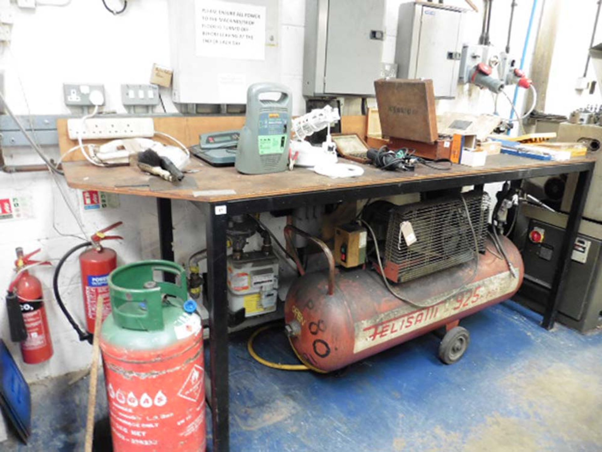 Welded metal workbench with plywood top, 8' wide approx (excluding contents)