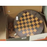 Chess board with quantity of carved African chess pieces