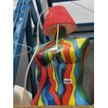A painted mannequin lamp