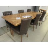 Extending dinning table with parquet style surface with 6 button back leather upholstered chairs