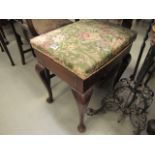 Floral upholstered stool on castors