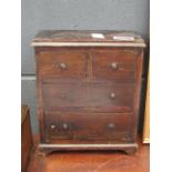 A miniature trinket box in the form of a chest of drawers