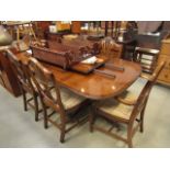 Extending dining table in dark wood with six dining room chairs with wheat ear design