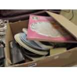 A box containing a silver plated cake tray, coffee mugs, crockery and household goods