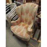 Edwardian wingback armchair with carved frame