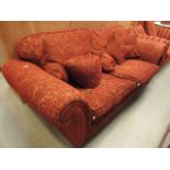 Red and gold floral patterned three seater sofa