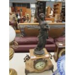 A marble mantle clock with spelter figure over