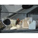 A cage containing ornamental figures, photo frames, lidded pots plus glassware