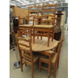 Circular pine dining table plus 6 rush seated chairs to include 2 carvers