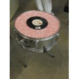 A drum coffee table on raised supports