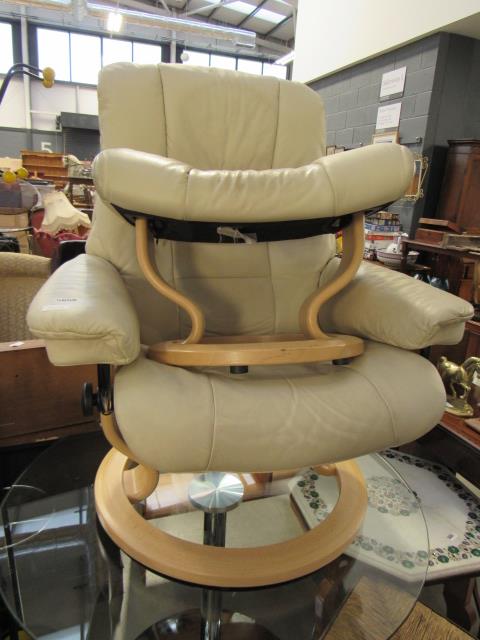 Cream leather swivel lounge chair with stool