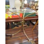 Contemporary design occasional table with brass support and circular glass top