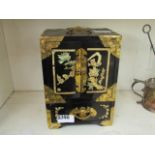 A black lacquered and brass bound Oriental jewellery box with mother of pearl inlay