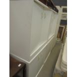 Four cream painted double-door storage cabinets