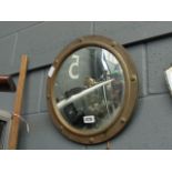 A convex mirror in brass frame