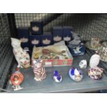 A cage containing Crown Derby figures, purses, badges and a crystal figure of a bird