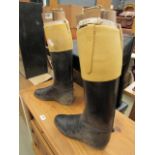 Pair of black leather riding boots with woolen stretchers